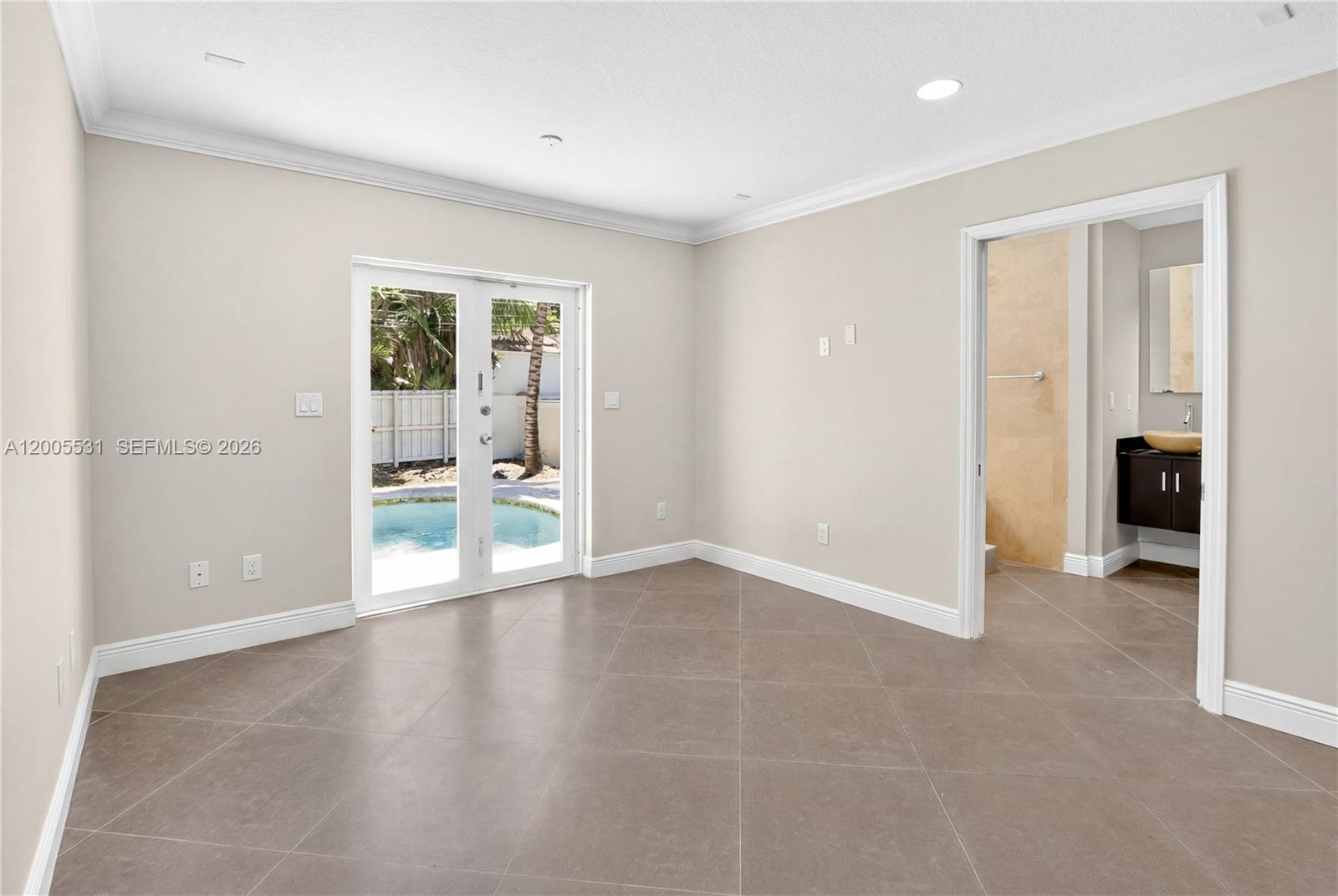 5310 Southwest 72nd Street Miami, FL 33143 - Photo 12 of 20 an empty room with large windows and a fireplace