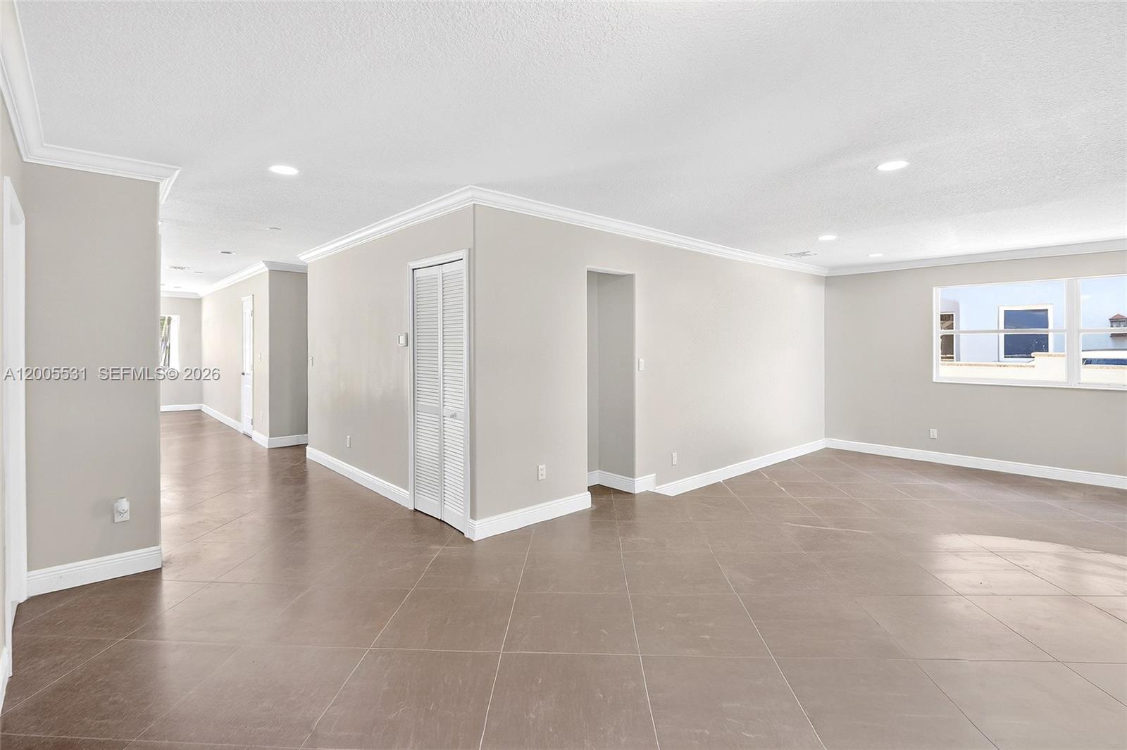 5310 Southwest 72nd Street Miami, FL 33143 - Photo 6 of 20 a view of an empty room with wooden floor and a window