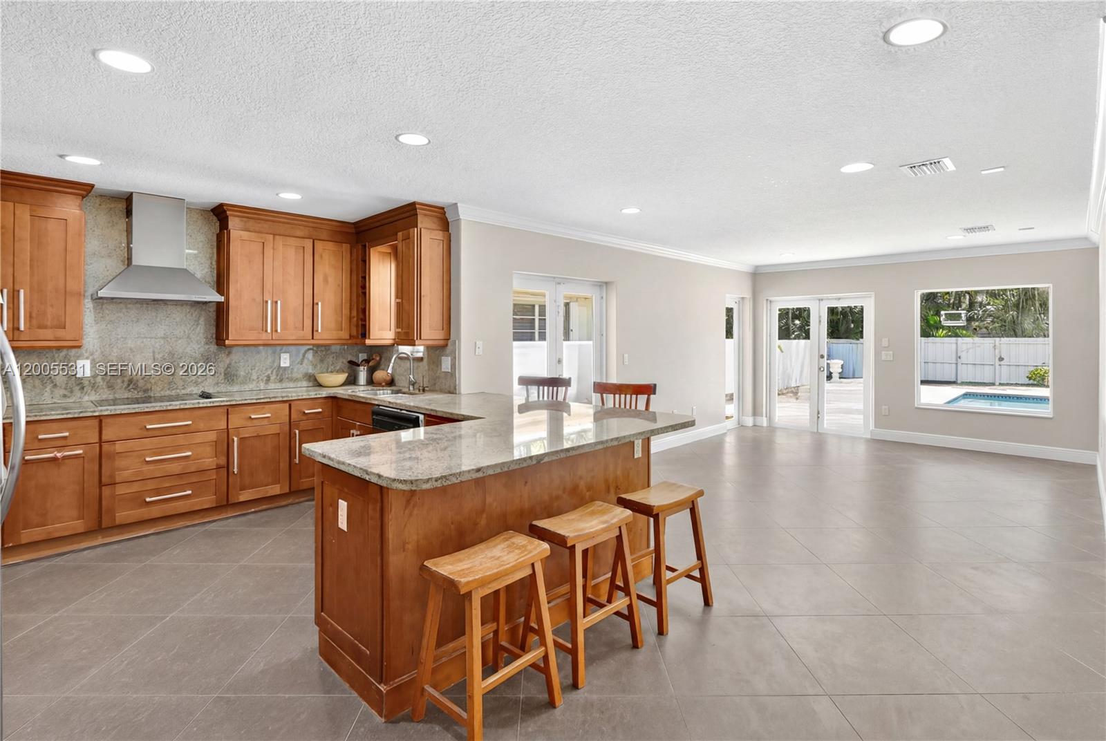 5310 Southwest 72nd Street Miami, FL 33143 - Photo 8 of 20 a kitchen with a stove a sink a oven a dining table and chairs