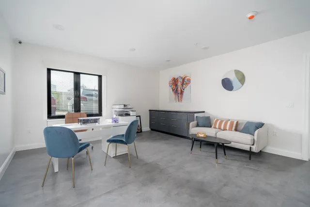 a kitchen with stainless steel appliances granite countertop a sink and a refrigerator