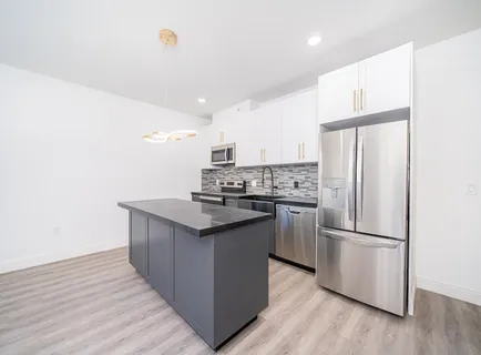 a kitchen with wooden cabinets and stainless steel appliances