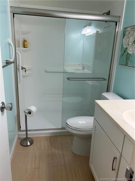 2950 Southeast Ocean Boulevard, Unit 1323 Stuart, FL 34996 - Photo 11 of 19 a white toilet sitting next to a shower