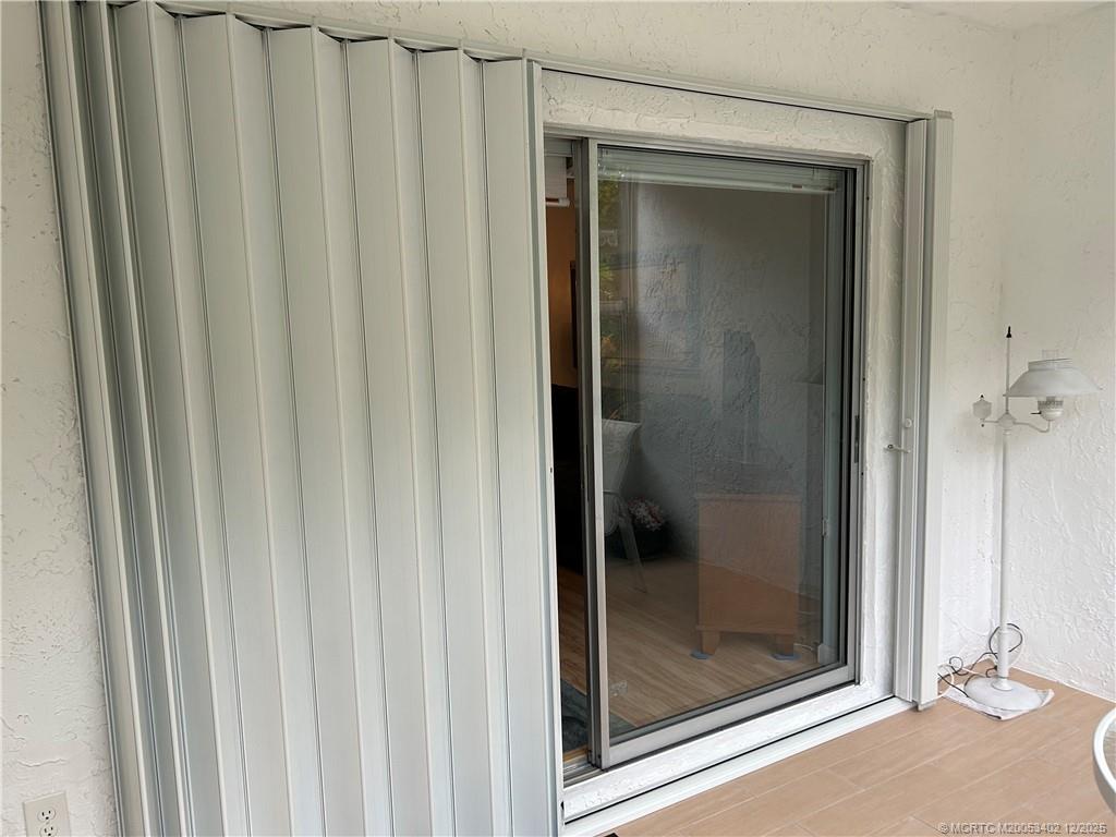 2950 Southeast Ocean Boulevard, Unit 1323 Stuart, FL 34996 - Photo 18 of 19 a bathroom with a glass shower door