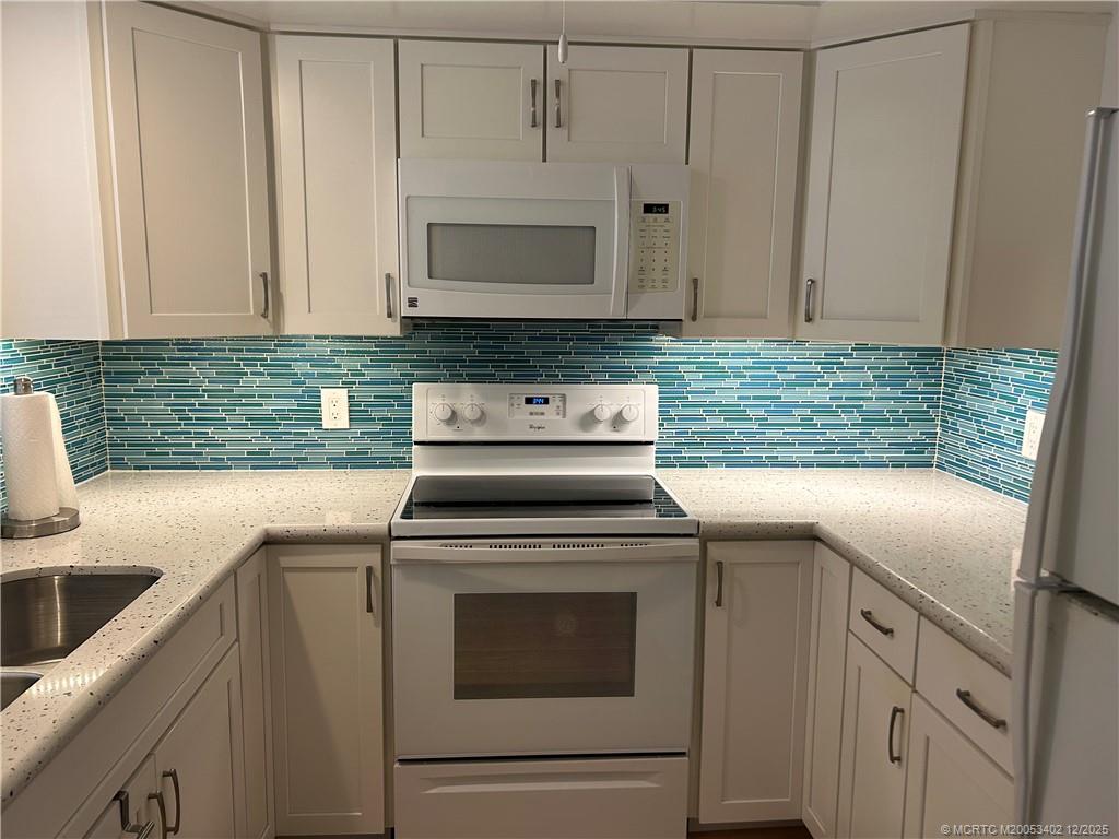 2950 Southeast Ocean Boulevard, Unit 1323 Stuart, FL 34996 - Photo 4 of 19 a kitchen with cabinets appliances and a sink