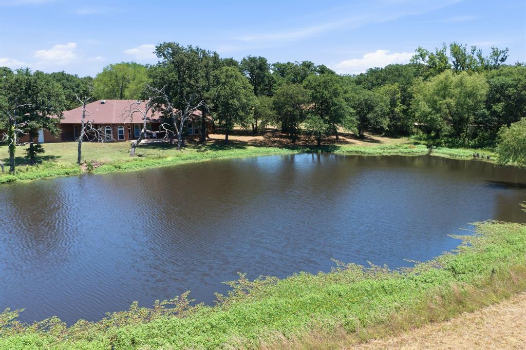321 Cr 211 Road Gainesville, TX 76240 - Photo 25 of 40 Peaceful pond behind the main home.