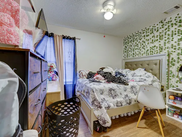 a bed room with a bed and a chair