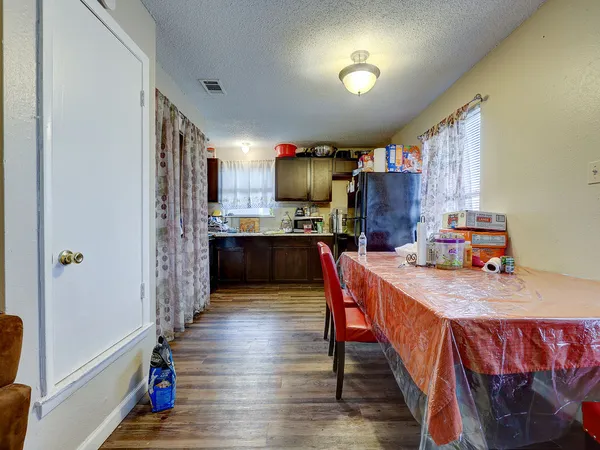 a dining room with furniture and wooden floor
