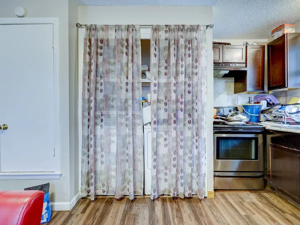 a kitchen with stainless steel appliances a stove and a microwave oven