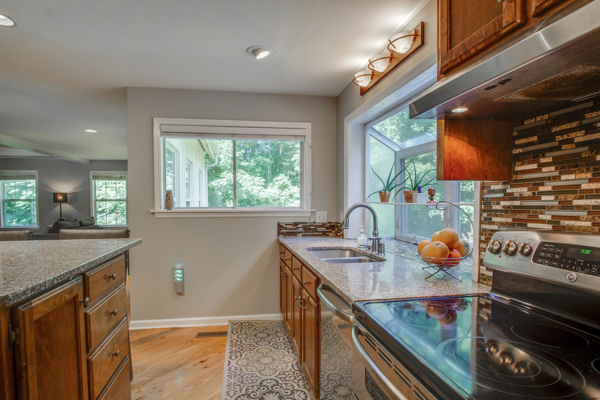 1111 Rip Steele Road Columbia, TN 38401 - Photo 23 of 50 a kitchen with stainless steel appliances granite countertop a sink stove and cabinets