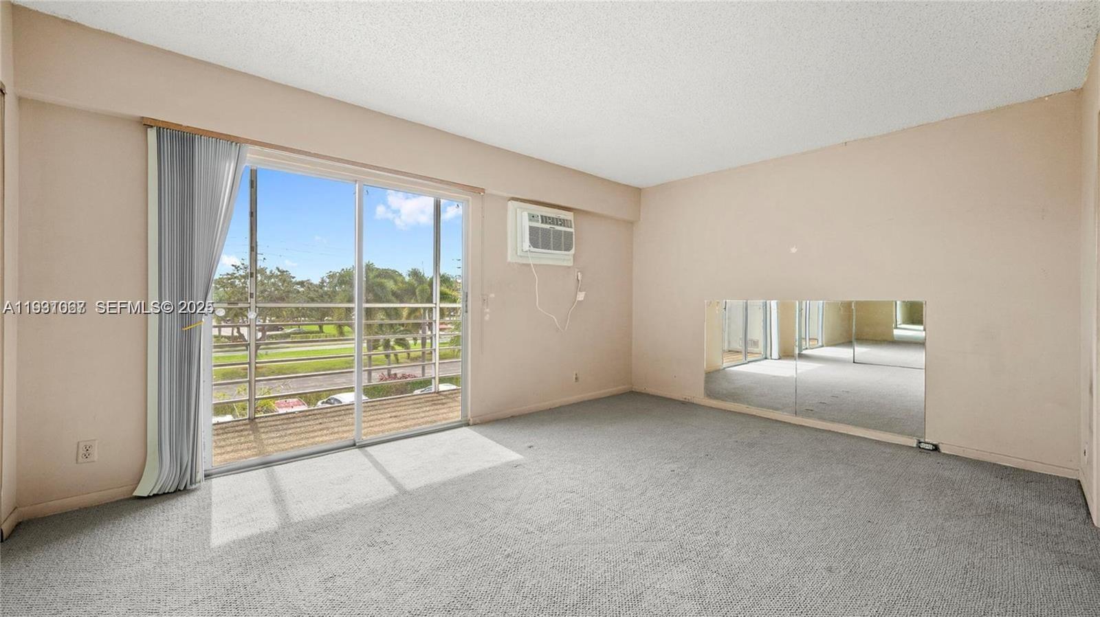79 Suffolk B, Unit 79 Boca Raton, FL 33434 - Photo 3 of 10 a view of an empty room with a window