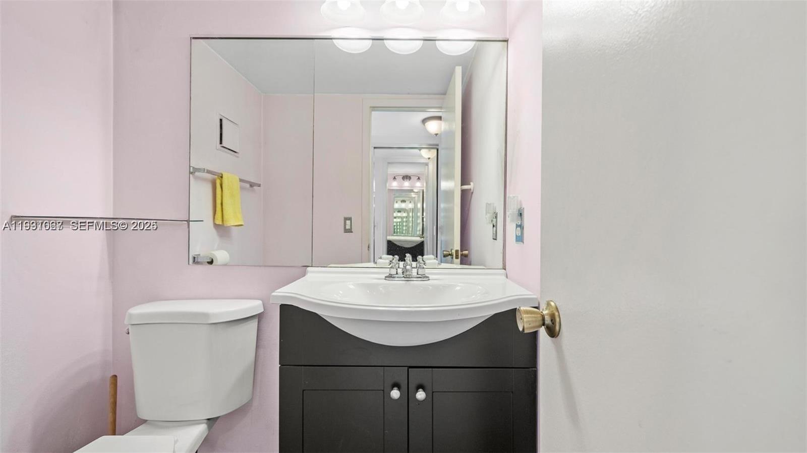 79 Suffolk B, Unit 79 Boca Raton, FL 33434 - Photo 4 of 10 a bathroom with a sink a toilet and mirror