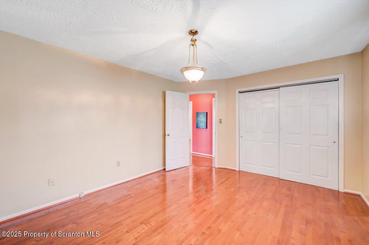 625 Cotter Street Moosic, PA 18507 - Photo 20 of 38 a view of an empty room with wooden floor and a window