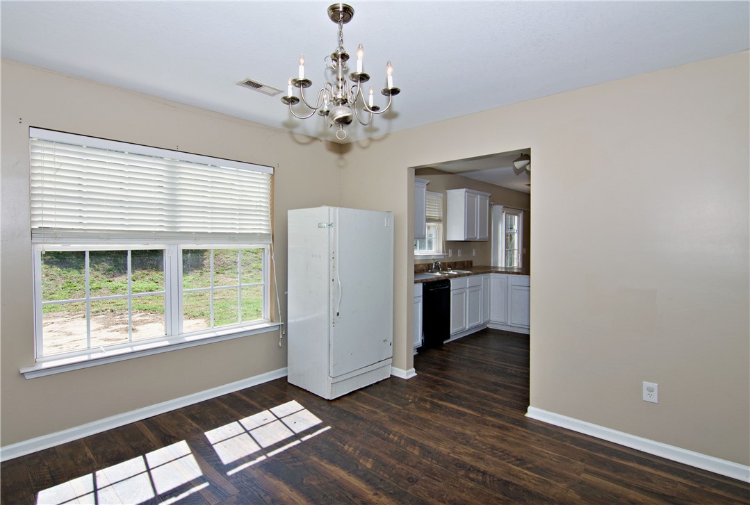 305 North Chestnut Street Seneca, SC 29678 - Photo 11 of 44 Durable wood-look flooring extends throughout this versatile space, perfect for dining or an additional living area.
