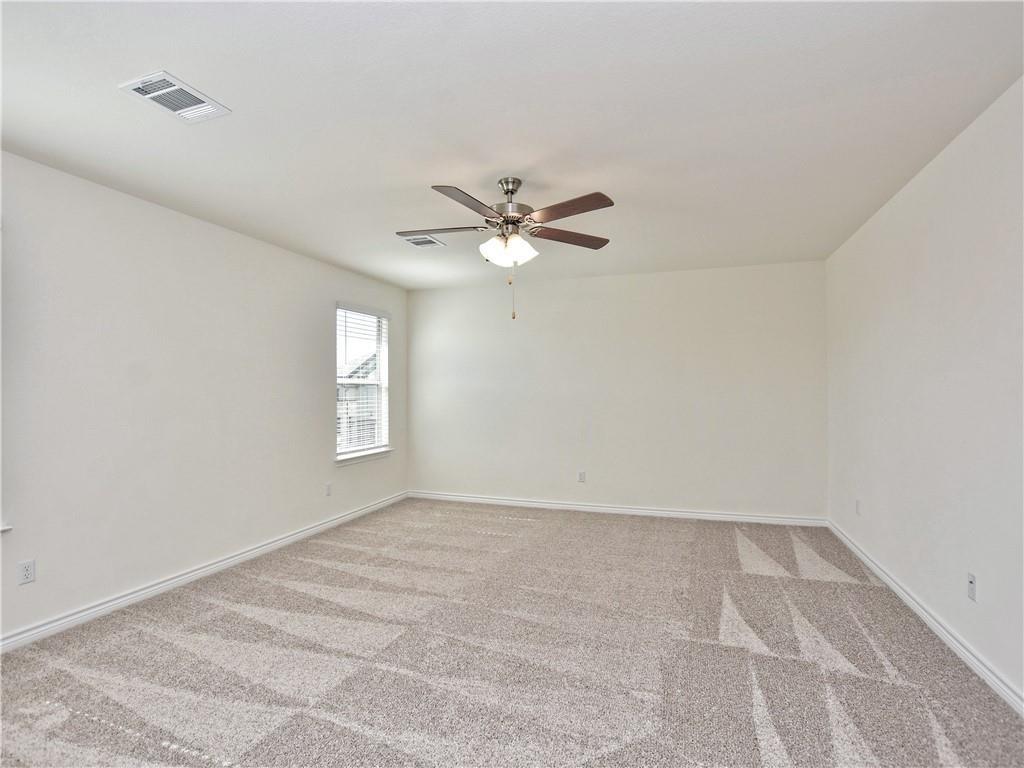 1836 Turtle Bay Loop Leander, TX 78641 - Photo 13 of 32 Spacious room featuring neutral carpeting, white walls, a single window with blinds, a ceiling fan with integrated lighting, and white baseboards