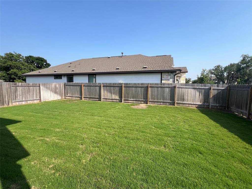 1836 Turtle Bay Loop Leander, TX 78641 - Photo 22 of 32 Expansive rear yard featuring green lawn and wood privacy fencing