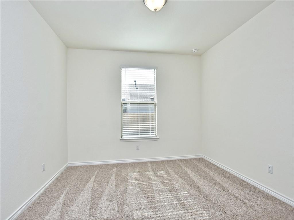 1836 Turtle Bay Loop Leander, TX 78641 - Photo 10 of 32 Neutral-toned room featuring a single window with blinds, light beige patterned carpet, and a ceiling-mounted light fixture