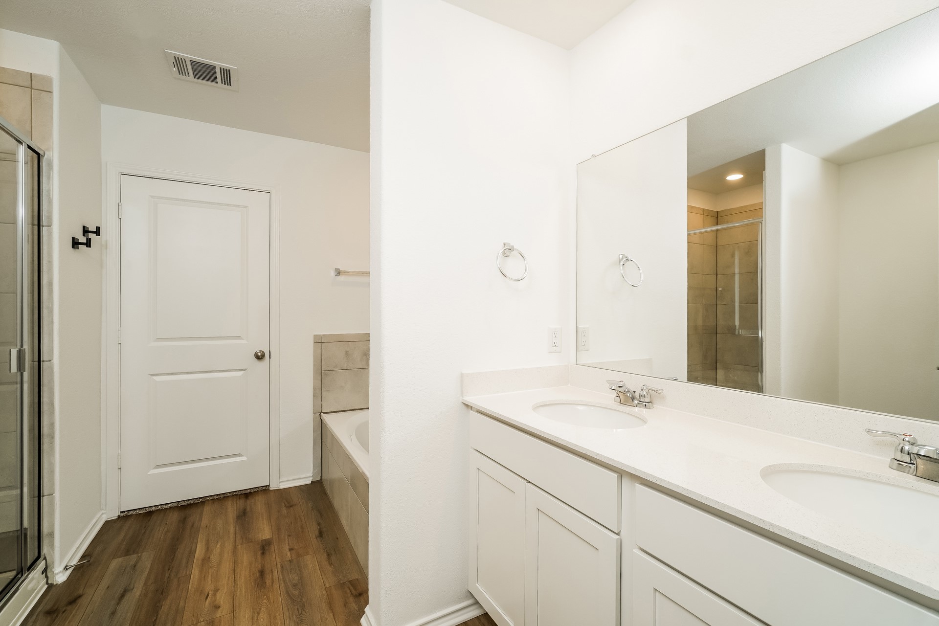 341 Madrid Kyle, TX 78640 - Photo 15 of 27 Dual vanity sinks provide ample space for morning routines in this well-appointed bathroom.