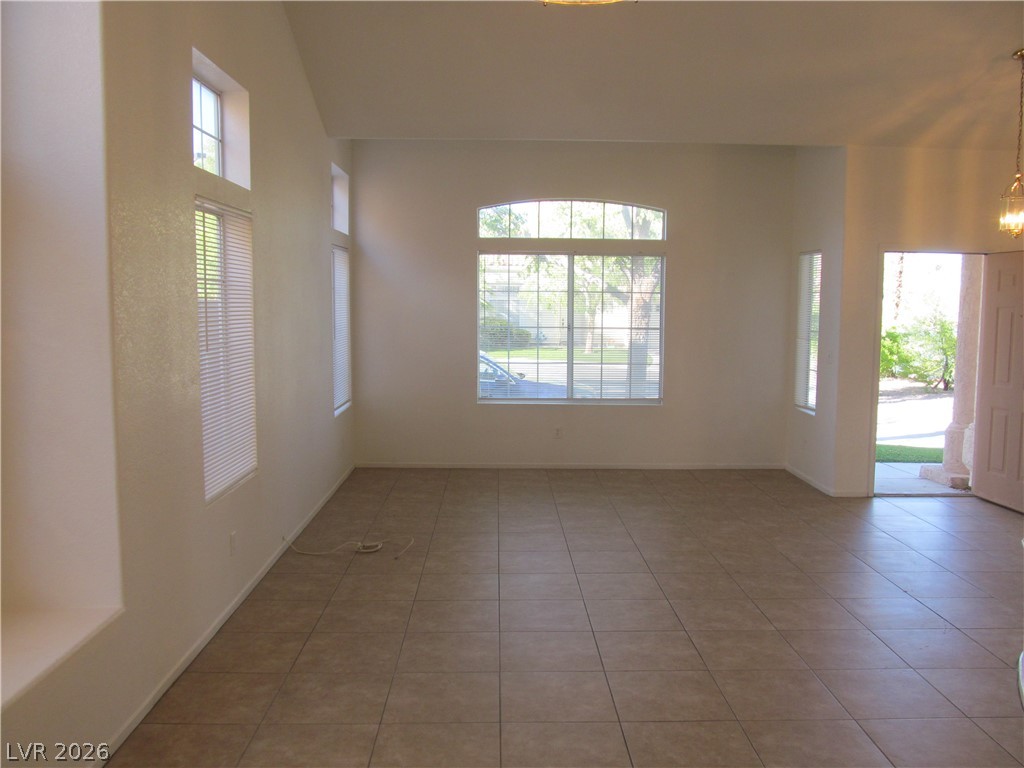 8701 Crescent Ridge Lane Las Vegas, NV 89134 - Photo 6 of 28 An inviting entry and living space feature ample natural light and durable tile flooring.