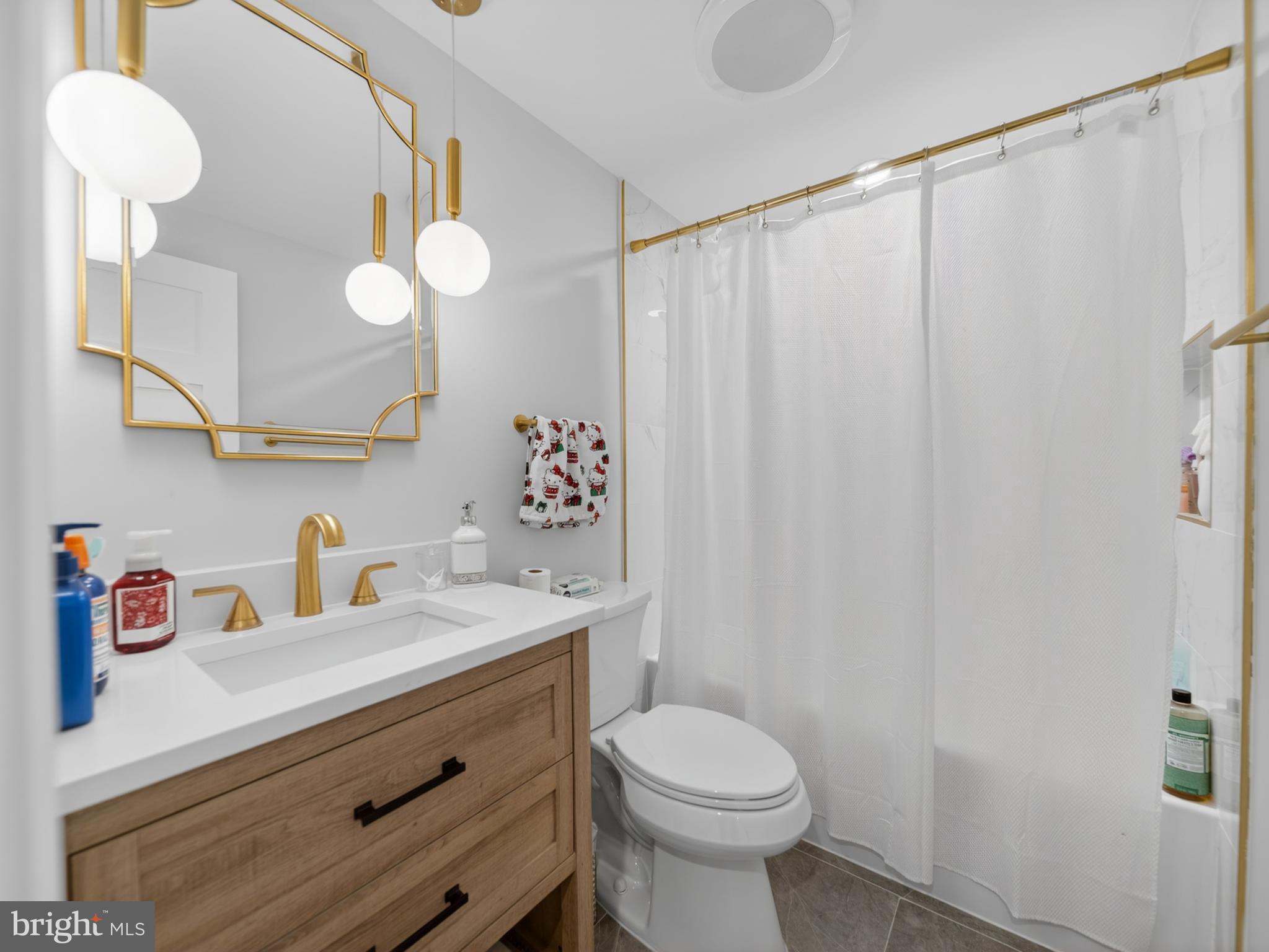 13427 Delaney Road Woodbridge, VA 22193 - Photo 37 of 57 a bathroom with a sink vanity mirror and toilet
