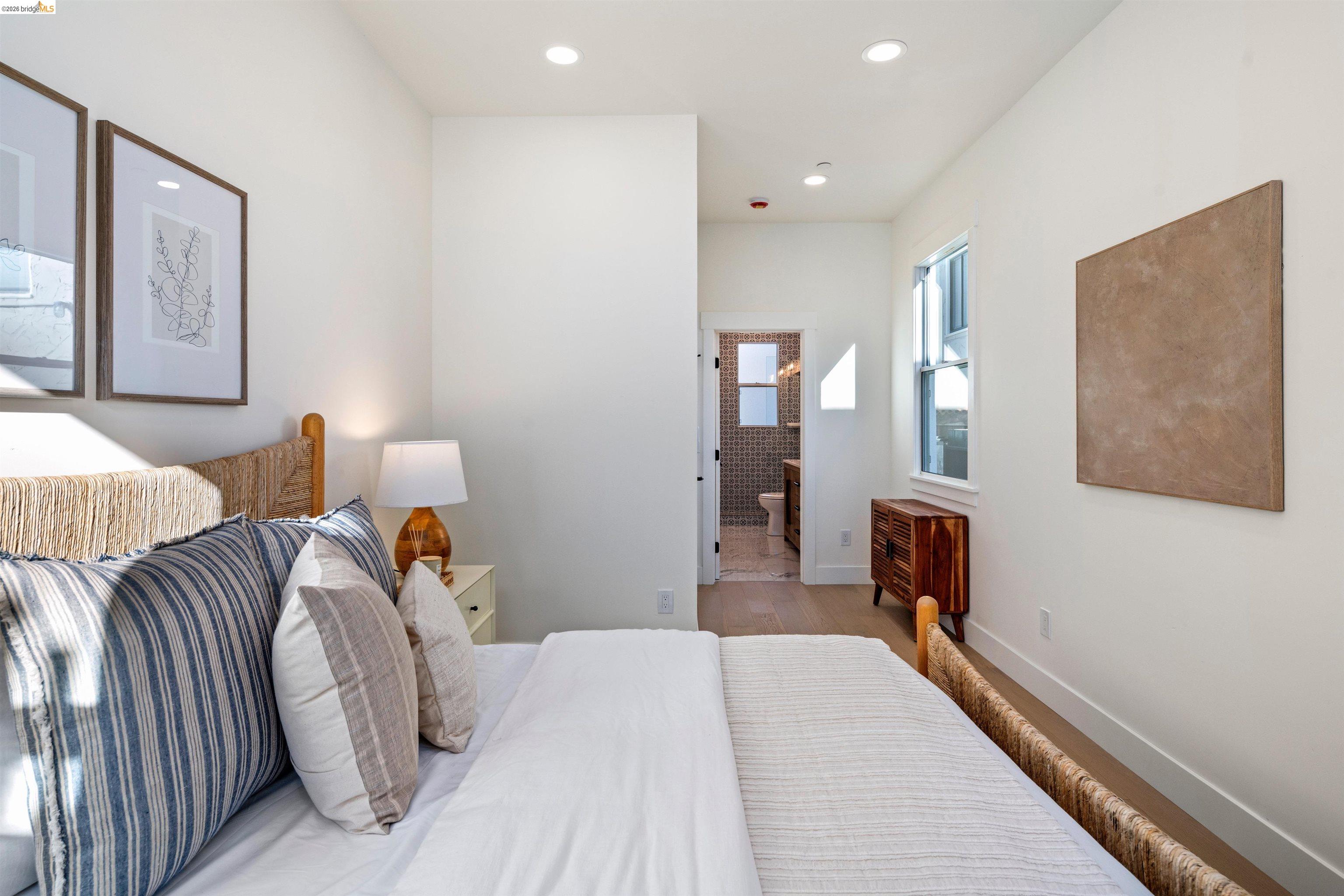 846 Adams Street Albany, CA 94706 - Photo 15 of 46 a bedroom with a bed and wooden floor