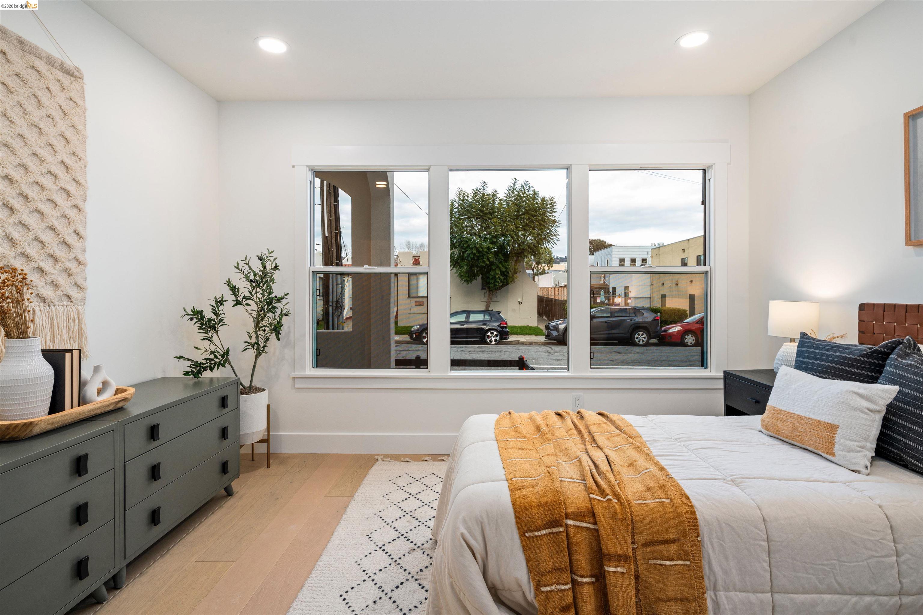 846 Adams Street Albany, CA 94706 - Photo 18 of 46 a spacious bedroom with a large bed and a couch