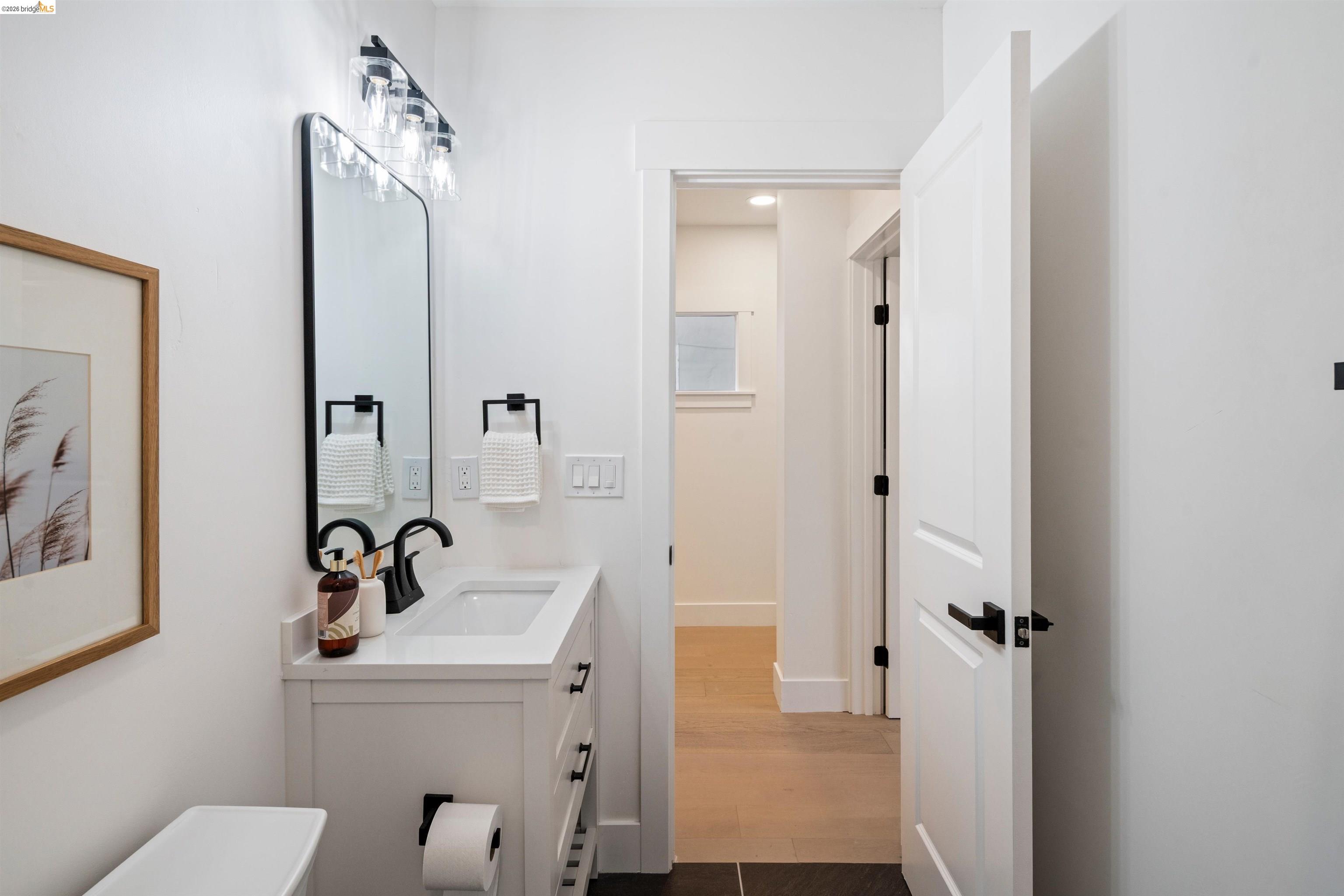 846 Adams Street Albany, CA 94706 - Photo 26 of 46 a bathroom with a sink a toilet and a mirror