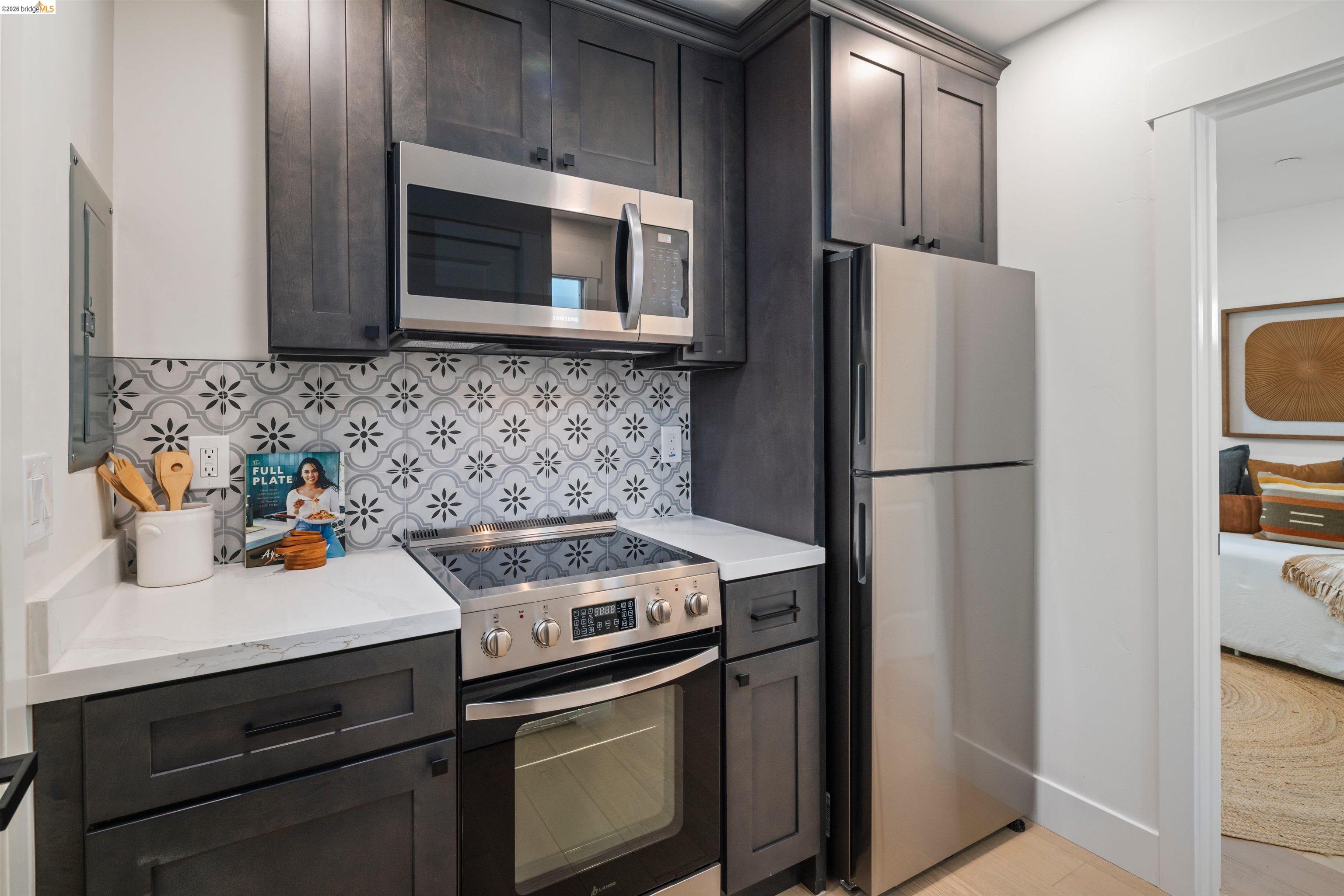846 Adams Street Albany, CA 94706 - Photo 30 of 46 a kitchen with stainless steel appliances a stove microwave and refrigerator