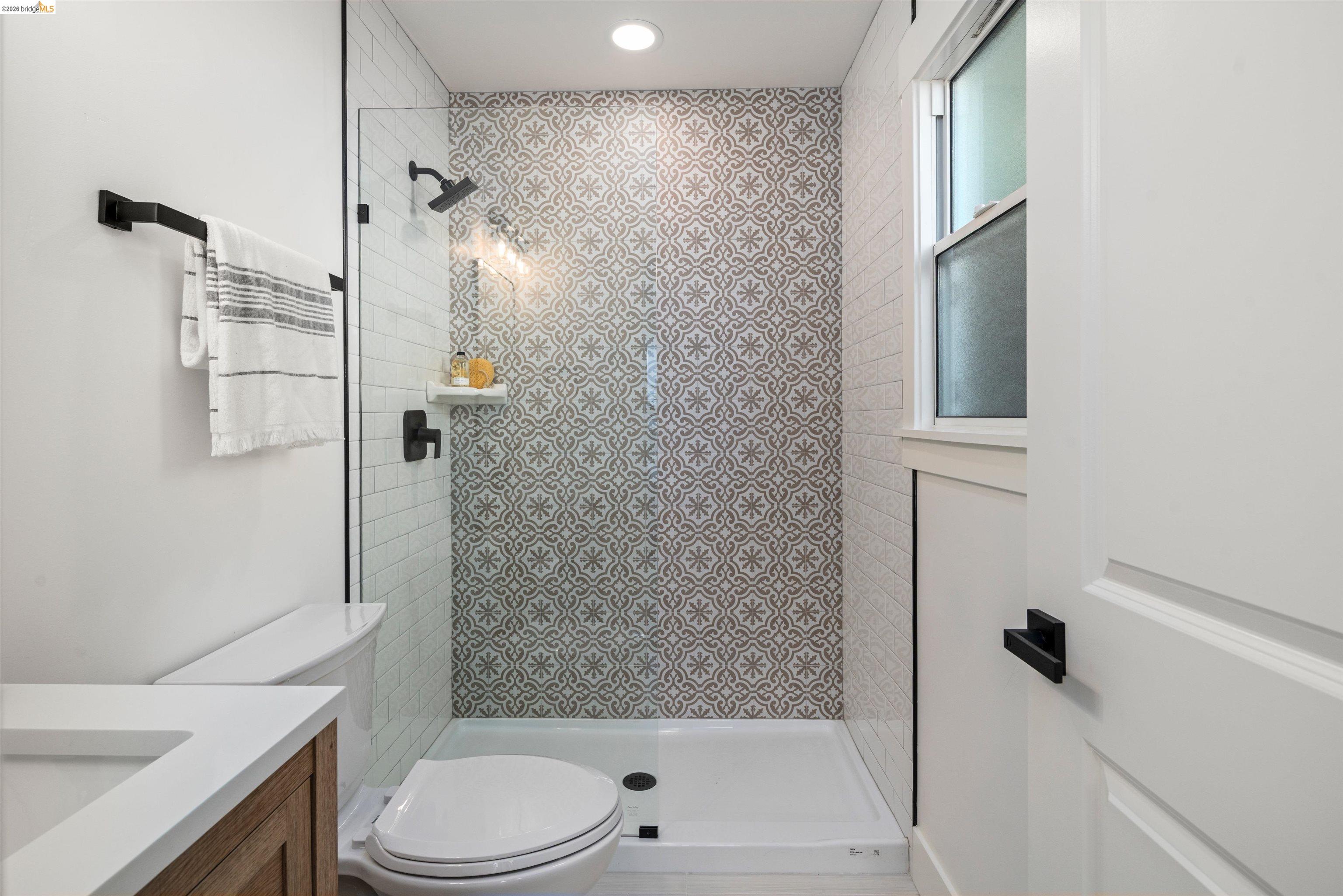 846 Adams Street Albany, CA 94706 - Photo 37 of 46 a bathroom with a shower a toilet and a sink