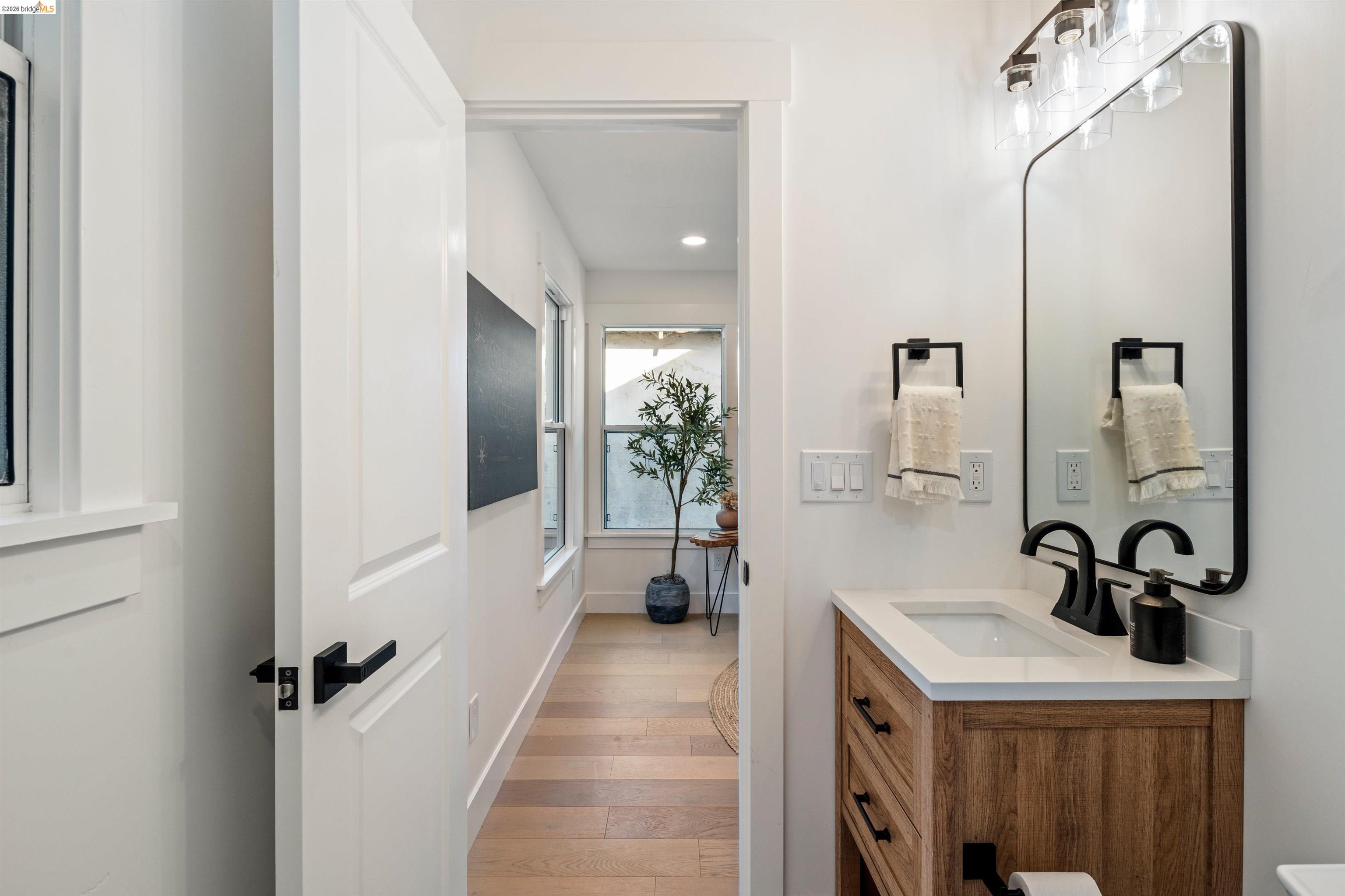 846 Adams Street Albany, CA 94706 - Photo 39 of 46 a bathroom with a sink a mirror and shower
