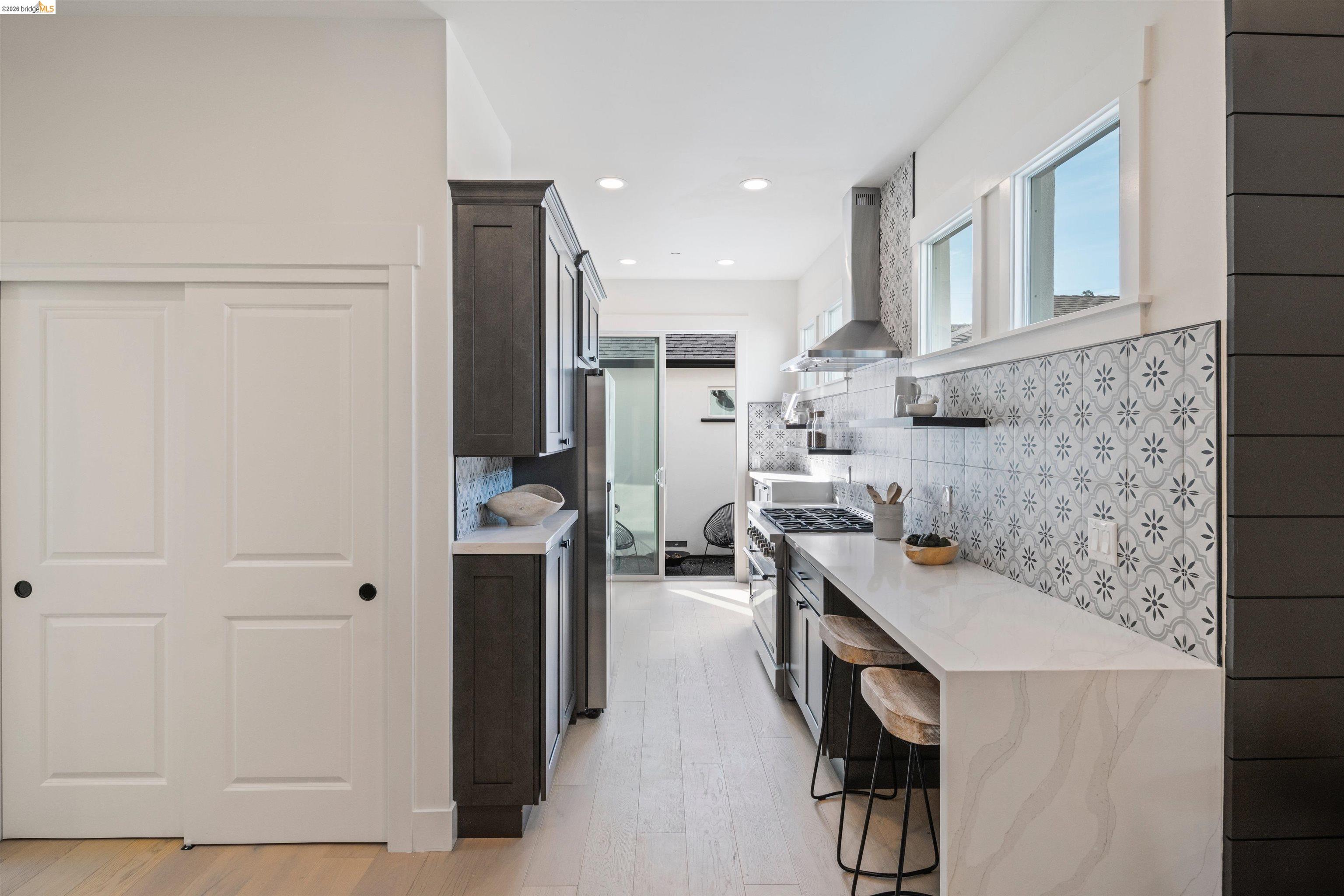 846 Adams Street Albany, CA 94706 - Photo 7 of 46 a kitchen with stainless steel appliances kitchen island granite countertop a refrigerator and a sink