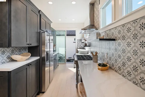 a kitchen with sink refrigerator and cabinets