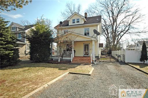 340 Bound Brook Road Middlesex, NJ 08846 - Photo 12 of 22 a view of a white house with a large tree in front of it