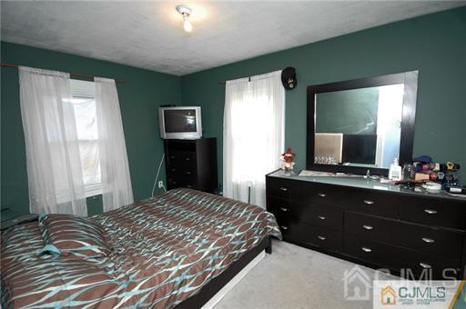 340 Bound Brook Road Middlesex, NJ 08846 - Photo 3 of 22 a bedroom with a bed and a flat screen tv
