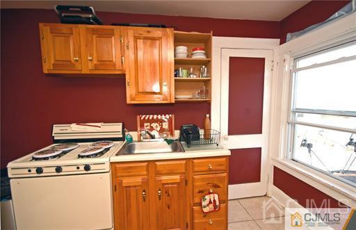340 Bound Brook Road Middlesex, NJ 08846 - Photo 7 of 22 a kitchen with a stove a sink and a refrigerator
