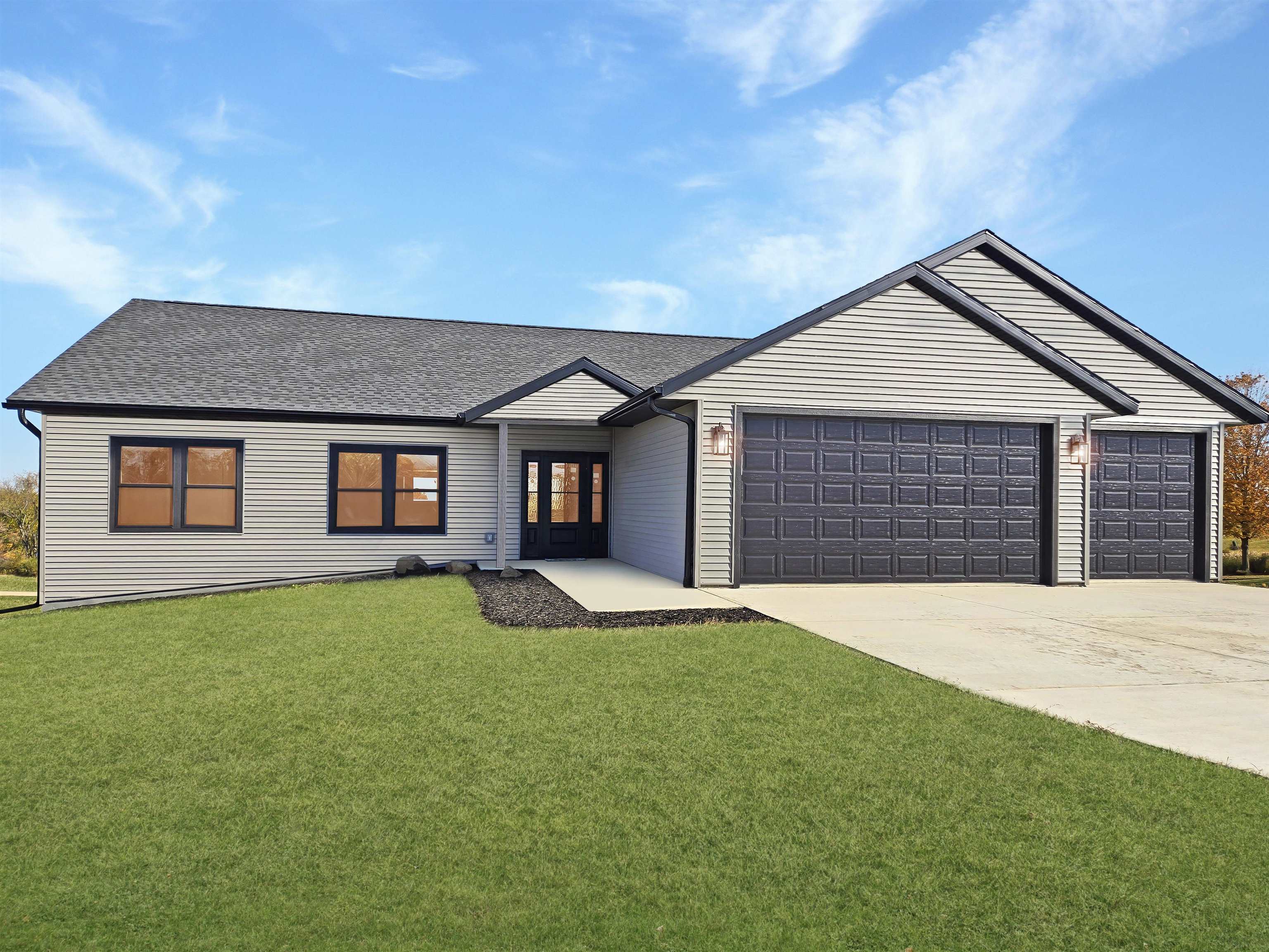 a front view of a house with yard and garage