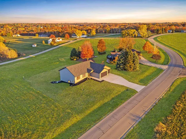 a kitchen with a dining table chairs and wooden floor