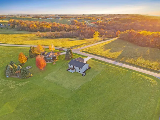 a kitchen with wooden floor white cabinets and stainless steel appliances