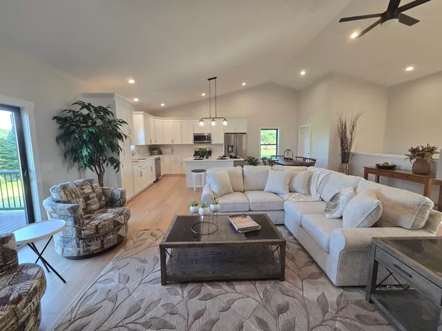 a bathroom with a toilet a sink a mirror a shower and vanity
