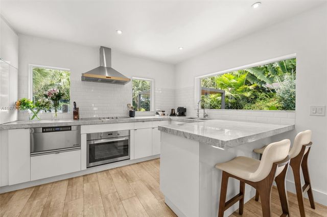 a kitchen with a stove a sink and a stove