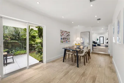 a dining room with furniture and wooden floor
