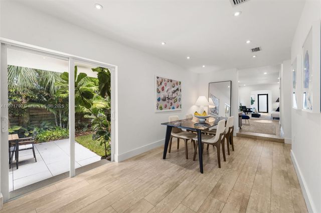 a dining room with furniture and wooden floor