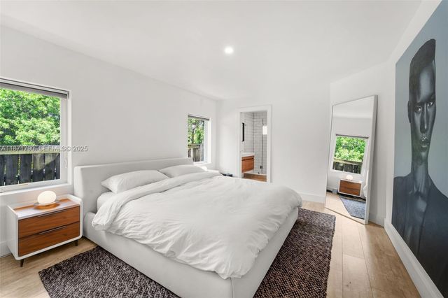 a bedroom with double bed and a window