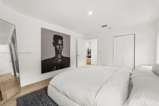 a bedroom with a bed and a dresser