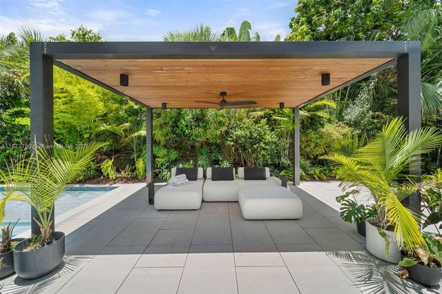 a view of a patio with couches and potted plants