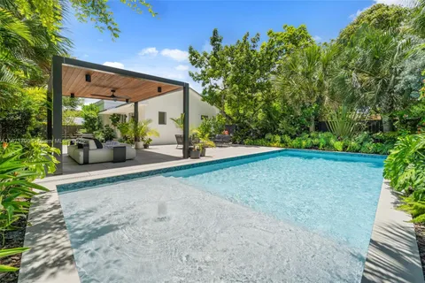 a view of a patio with table and chairs and potted plants