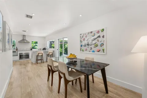 a dining room with furniture and wooden floor