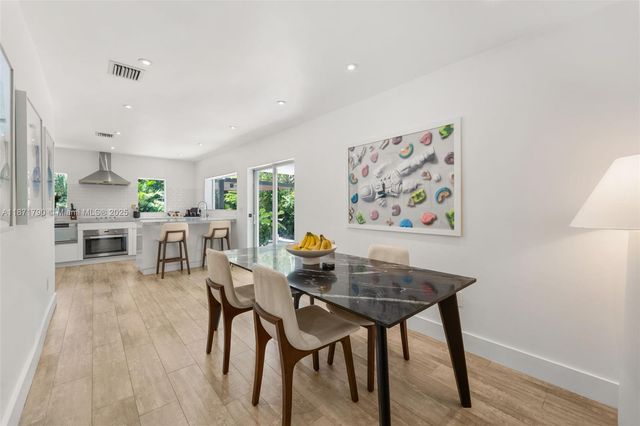 a dining room with furniture and wooden floor