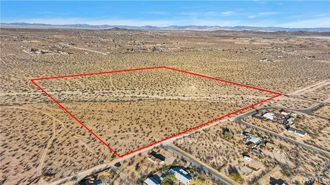 a view of mountain with sunset in background