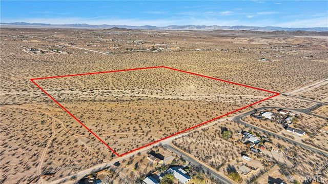 a view of mountain with sunset in background