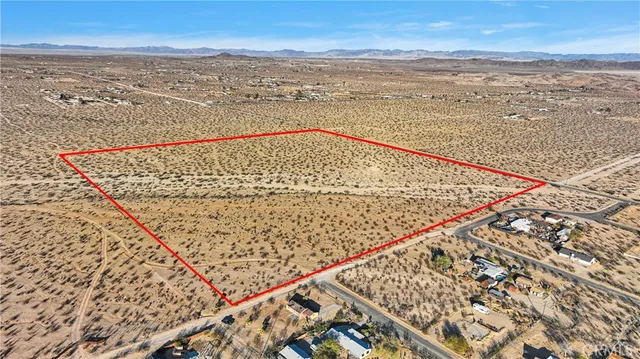 a view of mountain with sunset in background